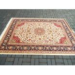 A Keshan carpet with a beige ground, approx 280cm x 200cm,