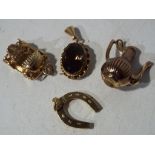 Two 9 ct gold charms in the form of a car and a horseshoe,