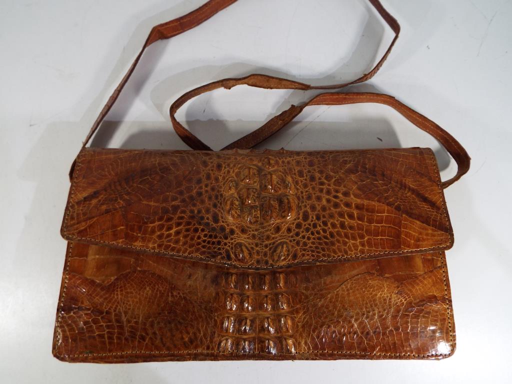 A good quality crocodile skin hand bag with internal zip compartment and strap measures