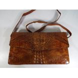 A good quality crocodile skin hand bag with internal zip compartment and strap measures