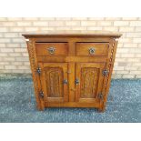 An oak two door cabinet approximate height 81 cm x 76 cm x 42 cm