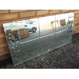 A decorative bevel edged wall mirror with a floral decoration approx 61cm x 123cm