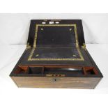 A writing slope hinged lid with black leather writing surface with gilded details with brass mounts,