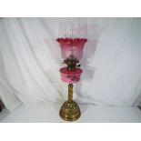 A vintage duplex oil lamp with brushed body,