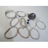 A collection of ten silver bangles and bracelets.