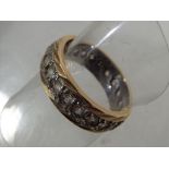 A lady's 9 carat gold stone set wedding band, size N, approximate weight 4.64 grams.