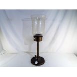 A brass and glass hurricane candle lamp,
