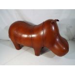 A leather footstool in the form of a hippo, approximate height 33 cm (h).