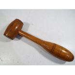 An oak carved gavel with brass detailing,