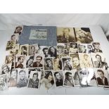A quantity of black and photographs and postcards depicting movie stars of the 1940s and a folder