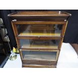 A three tier glass panelled barrister's bookcase circa 1930 by Gunn Furniture,