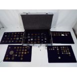 An aluminium case containing a quantity of UK and Foreign coins,