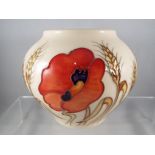 A Moorcroft vase in the Harvest Poppy pattern, approximate height 10 cm (h).