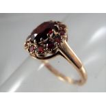 A lady's 9 carat gold hallmarked garnet cluster ring, approximate size K 1/2, approximate weight 2.