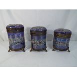 Three vintage blue glass and brass storage jars with hinged lids, hand painted decoration,