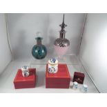 A lot to include two glass and white metal mounted perfume bottles,