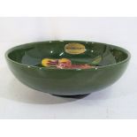 Moorcroft Pottery - a small Moorcroft Pottery footed bowl decorated with orchid on a green ground