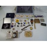 A sewing box, containing a quantity of mixed collectables to include pin badges, powder compacts,