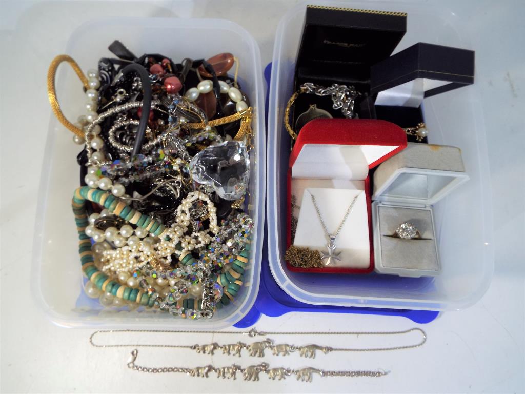 Two boxes containing a quantity of costume jewellery to include rings, necklaces,