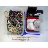 Two boxes containing a quantity of costume jewellery to include rings, necklaces,