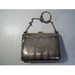 A silver hallmarked purse with engine turned decoration,