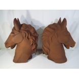 A pair of large cast horse's heads,