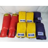 Three pairs of CONTENDER kickboxing gloves, one pair of DBE and a pair SANDEE shin pads.