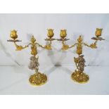 A pair of a silver gilt hallmarked two branch candelabra,
