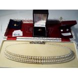 A double stranded graduated Elizabethan style pearl necklace with white metal stone set clasp,