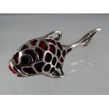 A silver pin cushion in the form of a fish.