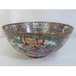 A large Japanese ceramic bowl, profusely decorated,