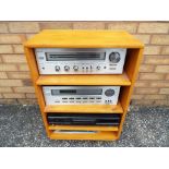 A light wood cabinet containing a Toshiba stereo amplifier, model number SB-445,