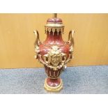 A decorative red marble based table lamp with applied brass detailing, with shade,