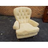 A good quality button back chair, the front two legs having castors.