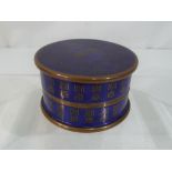 A vintage Asian enamelled lidded box of circular form with glass liner,