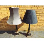 A matched pair of very good quality ornate black base metal with brass detailing table lamps with
