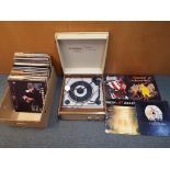 A vintage BSR Elizabethan Pop-Ten turntable and a quantity of 33 rpm vinyl records to include Queen,
