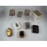 A collection of nine white and yellow metal vestas and snuff boxes and similar