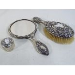 Three hallmarked silver dressing table items to include a Victorian silver lidded cut glass jar