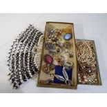 Two boxes containing a collection of costume jewellery to include a shoulder necklace, 17 brooches,