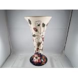 A Moorcroft vase in the Bramble Revisited pattern, approximate height 22 cm (h).