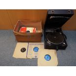 A triple tone portable gramophone with a quantity of 78 rpm vinyl records, Est £30 - £50.