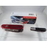 A Victorinox Cyber Tool multi function knife, contained in original box and a further penknife.