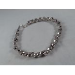 A white metal bracelet set with Swarovski crystals,