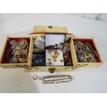 A jewellery box containing a large quantity of predominantly vintage costume jewellery to include