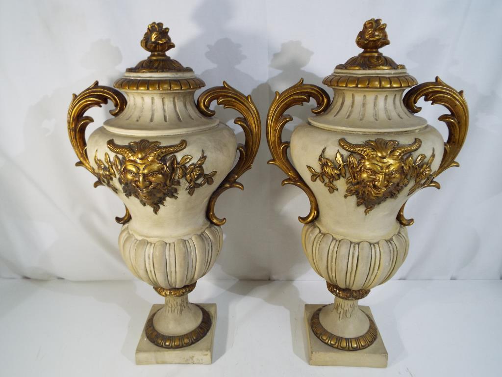 A large pair of cast plaster urns with featuring Pan and twin handles, approximately 55 cm [h] [2],