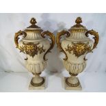 A large pair of cast plaster urns with featuring Pan and twin handles, approximately 55 cm [h] [2],