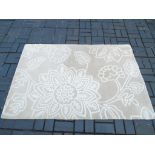 A 100% wool rug with stylised floral and foliate decoration,