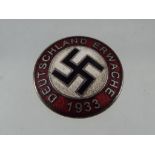 An enamelled pin badge Est £20 - £40