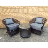 A faux rattan garden set, comprising of two chairs and a table, Est £30 - £40.